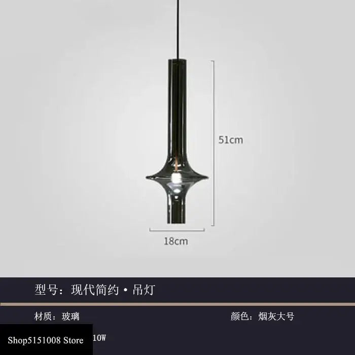 A sleek modern glass pendant light with smoked gray cylindrical glass body for kitchen hanging illumination