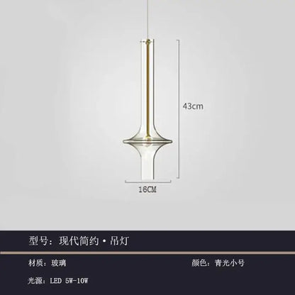 Modern minimalist glass pendant light with slender glass body and gold accents in cool blue green for kitchen use
