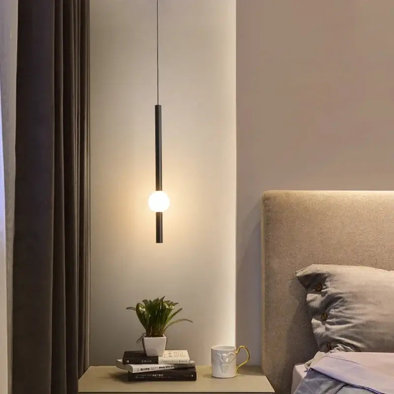 Black cylindrical rod pendant light with glowing spherical bulb modern minimalist glass rod pendant for living room