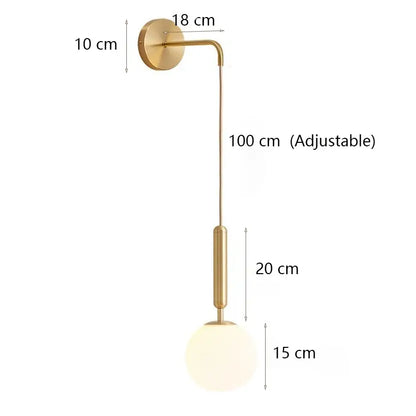 Modern minimalist wall lamp with gold finish, adjustable arm, and spherical frosted glass shade for bedroom lighting
