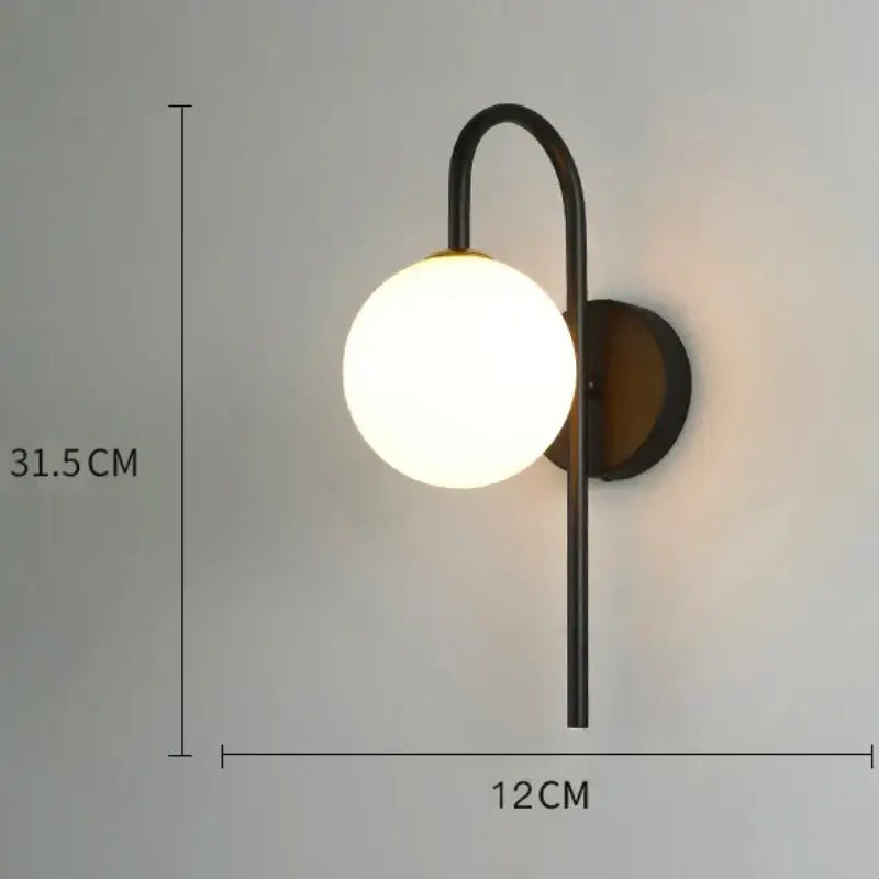 Modern minimalist black metal wall lamp with frosted glass globe and glass gold led accents for bedroom decorbites decor