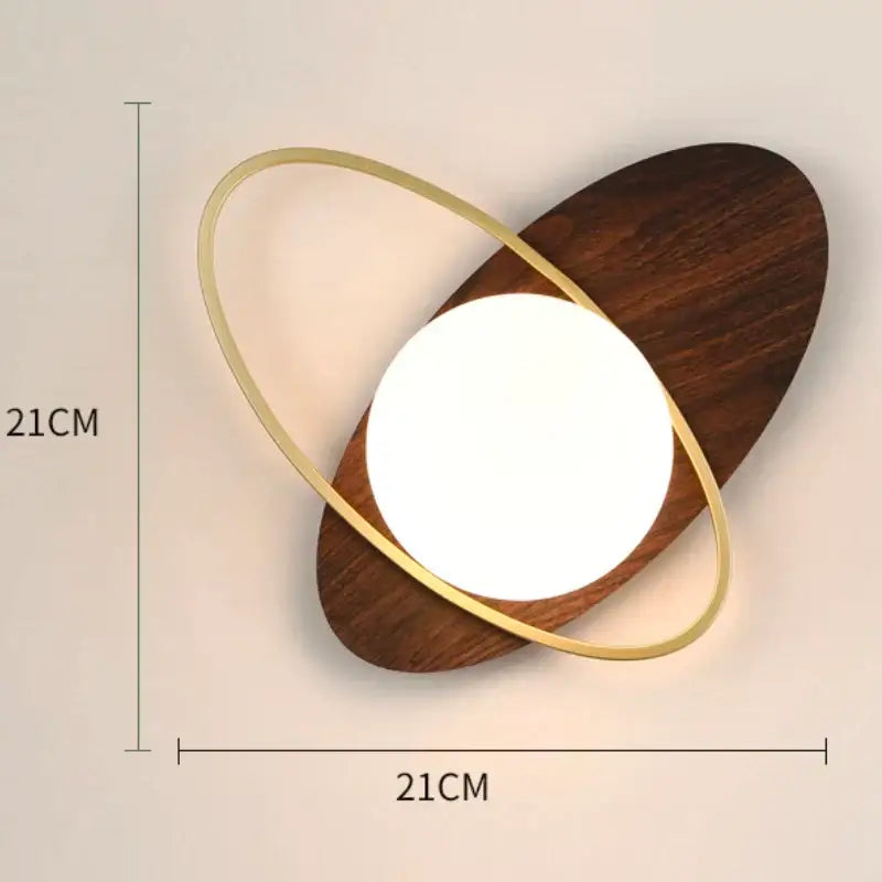 Modern minimalist gold and black glass gold led wall lamp with warm white light and dark wood base for bedroom decorbites glass gold