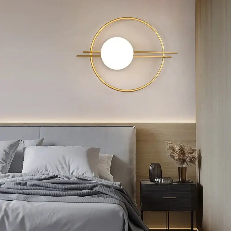Modern minimalist gold and black glass gold led wall lamp with circular gold-toned sconce and illuminated orb light