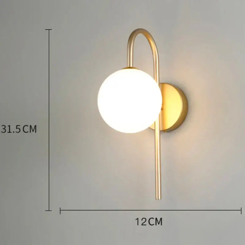 Modern minimalist gold wall lamp with glass gold led spherical frosted bulb and curved metal arm for bedroom decorbites glass gold