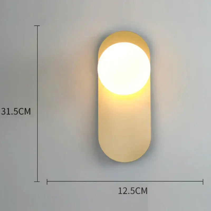 Modern minimalist gold and black glass gold led wall lamp with warm-toned oval design and smooth matte finish decorbites wall lamp
