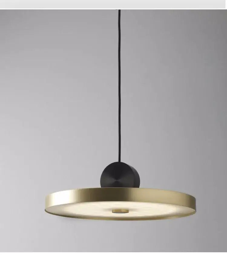 Modern minimalist gold and black led pendant light with sleek circular shade and matte suspension for dining room decorbites golden led