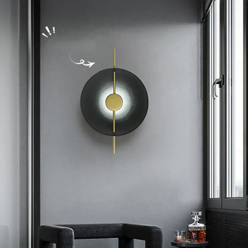Modern minimalist black circular led wall lamp with central gold disc and vertical gold accents for living room