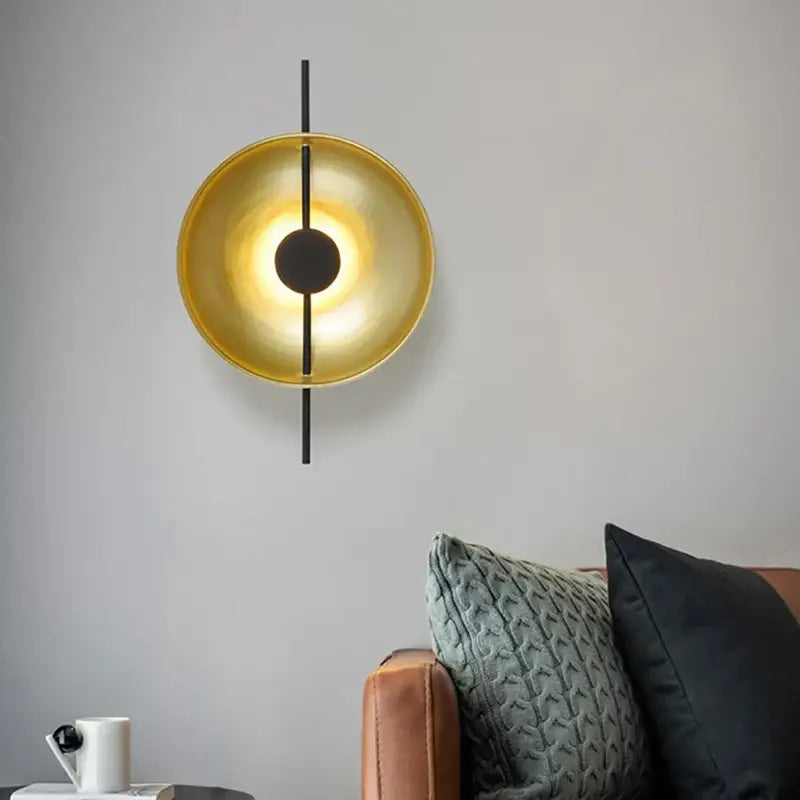 Modern minimalist gold and black led wall lamp with circular design and vertical rod accents for living room use