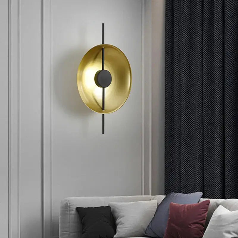 Modern minimalist gold and black led wall lamp with circular design and sleek black rod for living room lighting