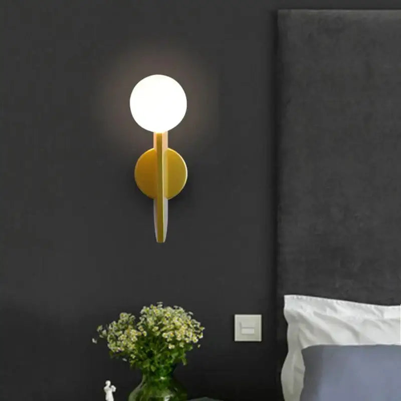 Modern minimalist yellow wall lamps with decorbites glass ball and geometric design for bedroom lighting