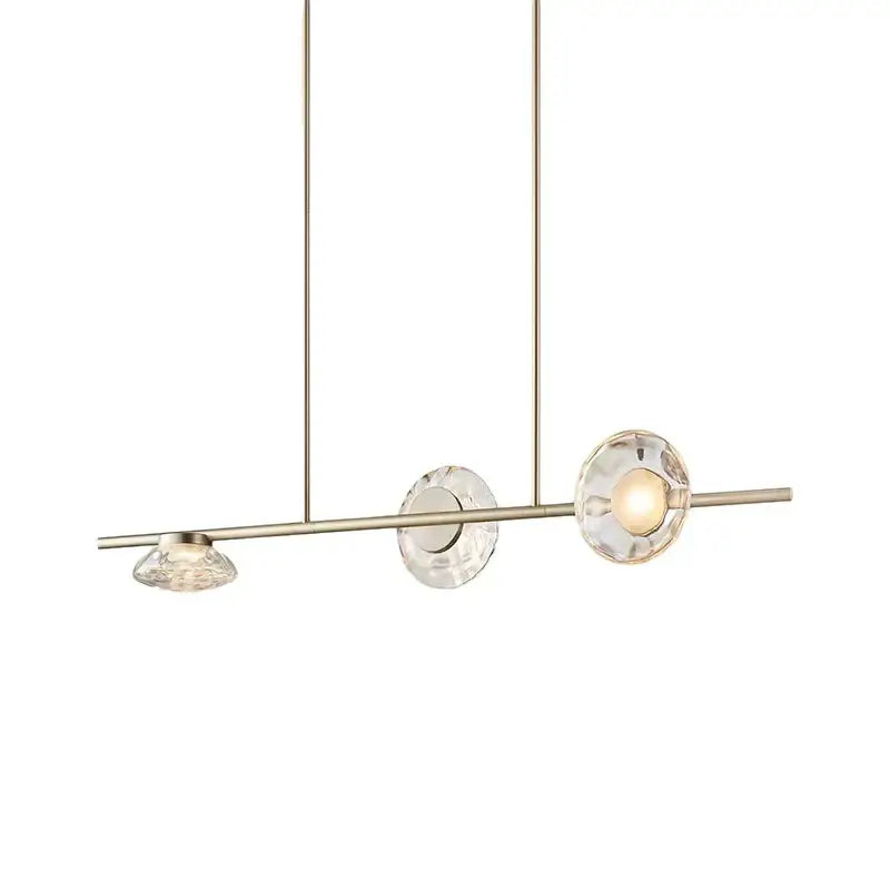 Modern minimalist gold glass led chandelier featuring a brushed brass frame and three faceted crystal shades