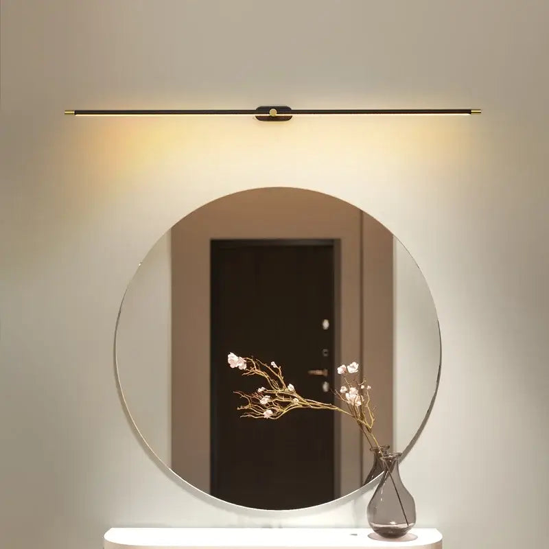 Modern minimalist circular led mirror light with sleek black frame and slim gold led bathroom wall fixture above