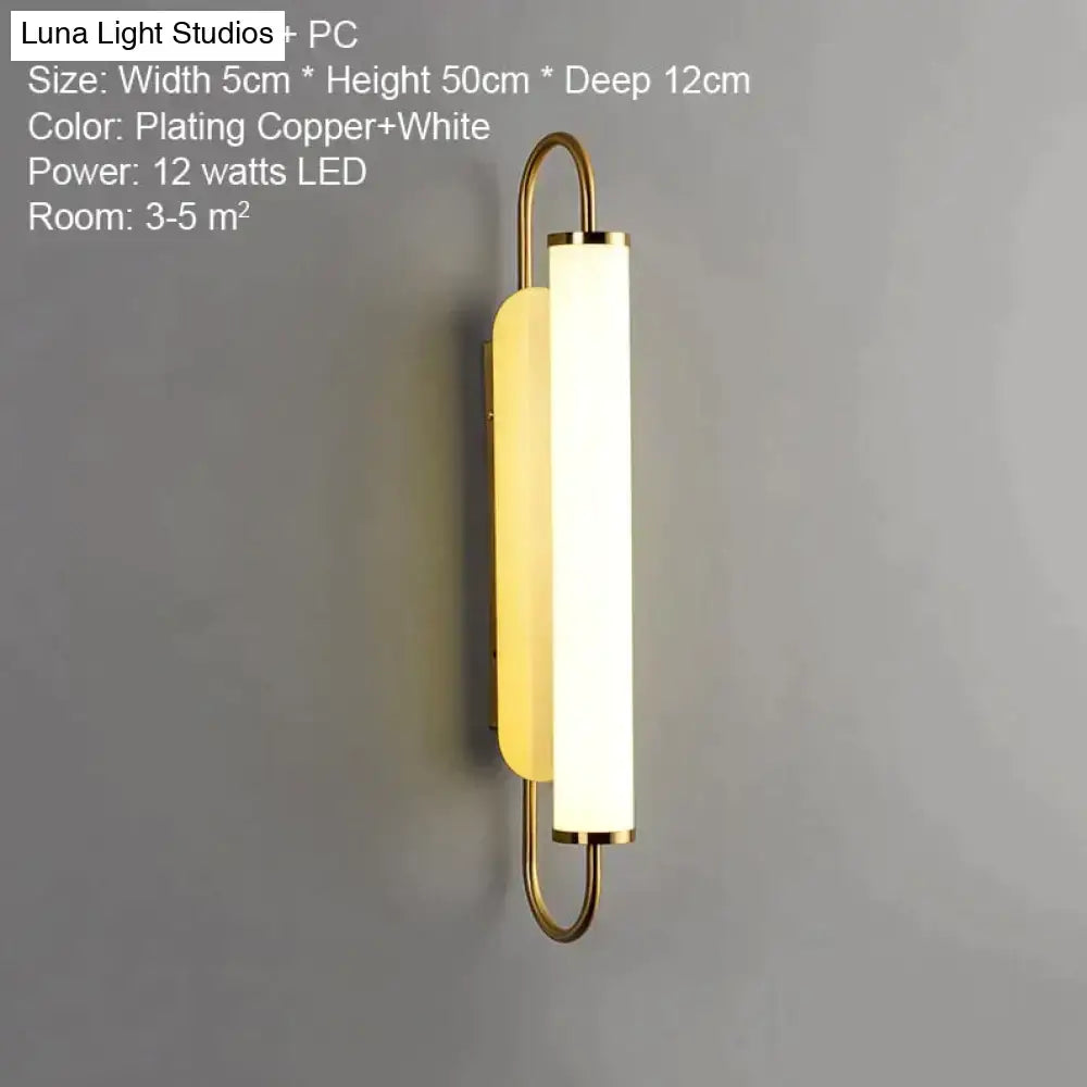 Modern minimalist copper-plated led wall lamp with elongated white diffuser and curved metal arms for bedroom sconce lighting