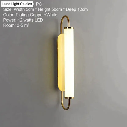 Modern minimalist copper-plated led wall lamp with elongated white diffuser and curved metal arms for bedroom sconce lighting