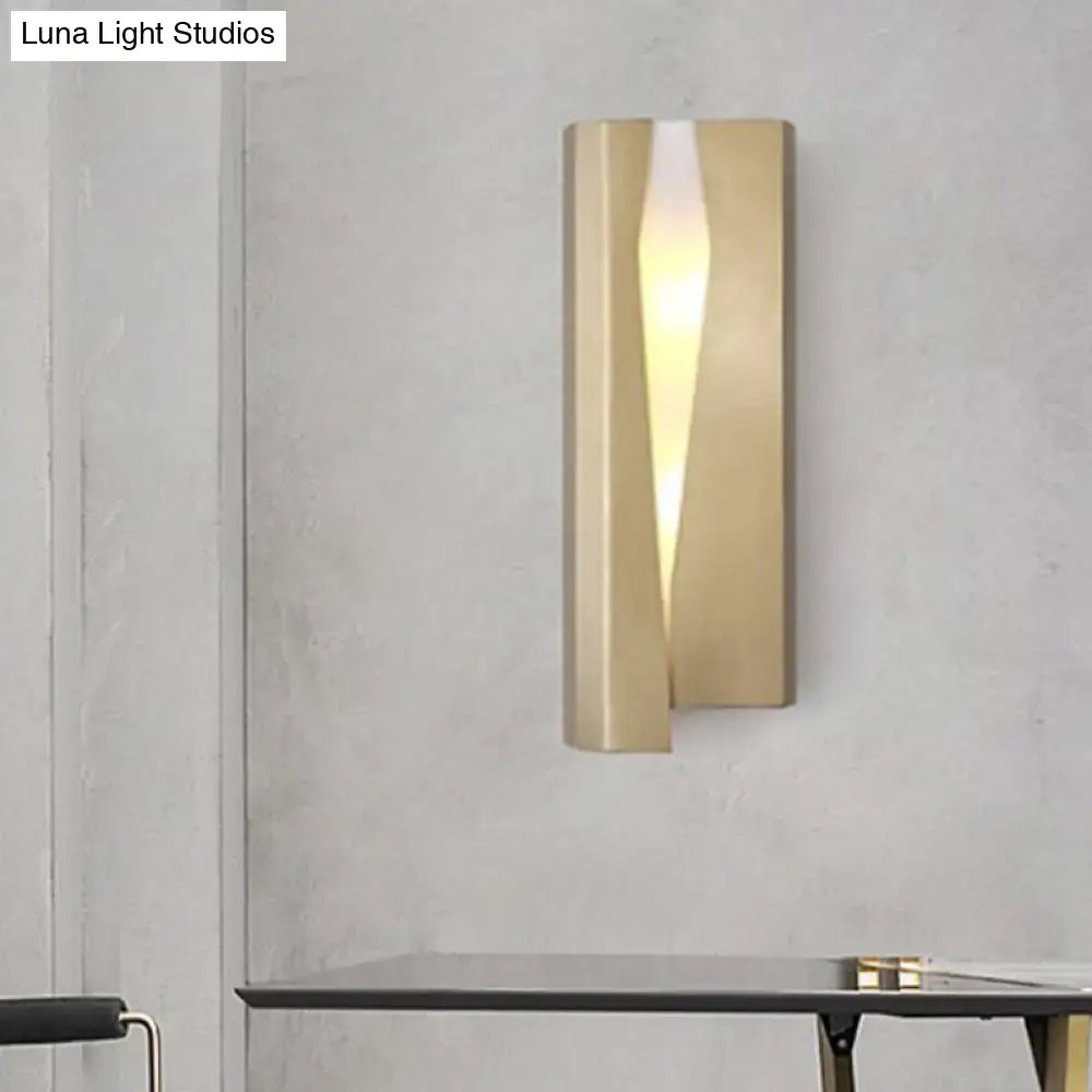 Modern minimalist gold metal rectangle wall sconce light with sleek angular design and warm central slit illumination
