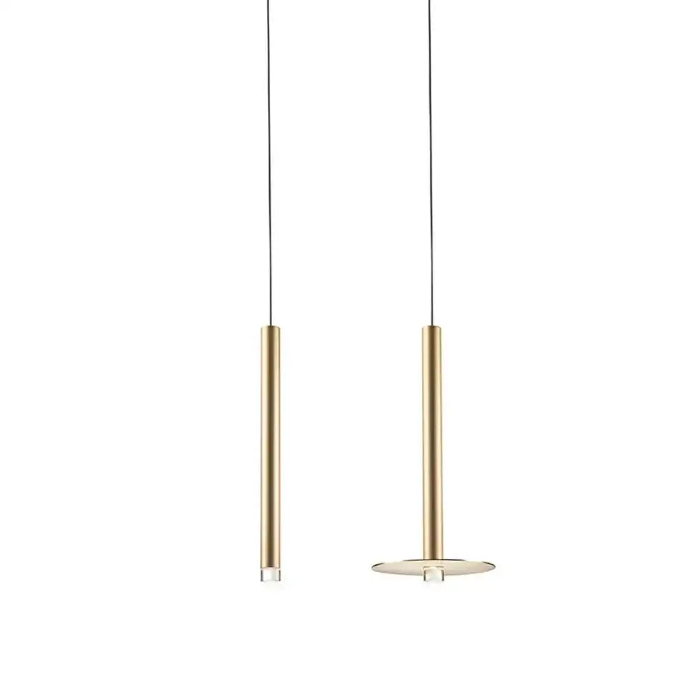 Two minimalist decorbites gold tube led pendant lights with slender gold cylindrical bodies and thin black cords for kitchen decor