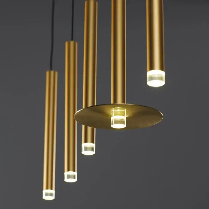 Modern minimalist gold tube led pendant lights with cylindrical design and warm led illumination for kitchen decorbites
