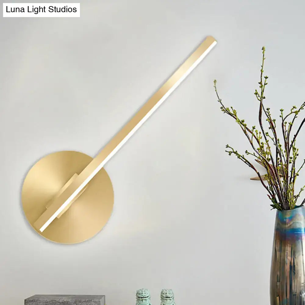 Modern minimalist gold tube stick wall sconce with sleek angular design and circular base for bedroom led lighting