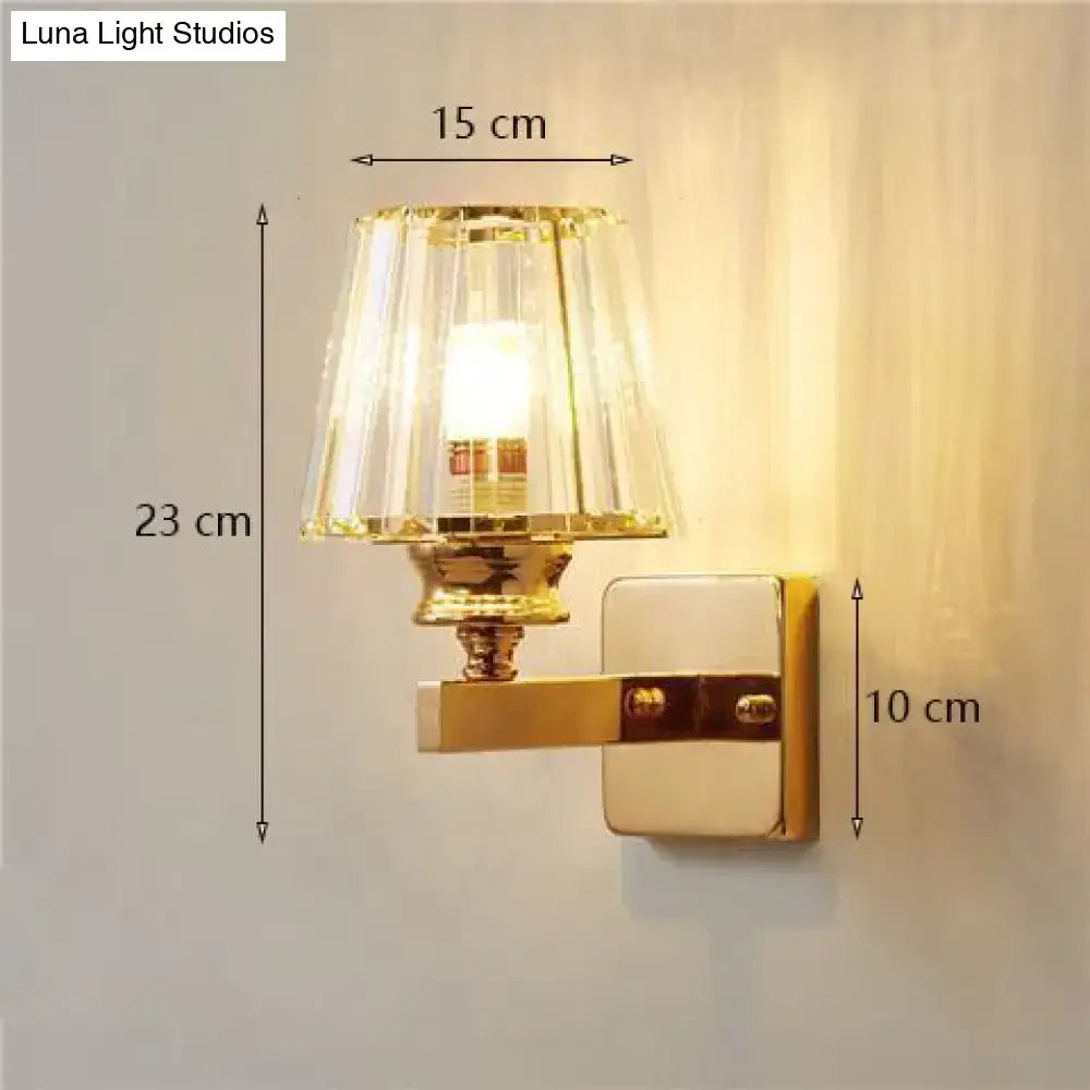 Modern minimalist wall lamp with gold finish and fluted clear glass crystal shade for bedroom lighting
