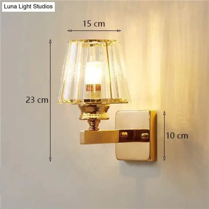 Modern minimalist wall lamp with gold finish and fluted clear glass crystal shade for bedroom lighting