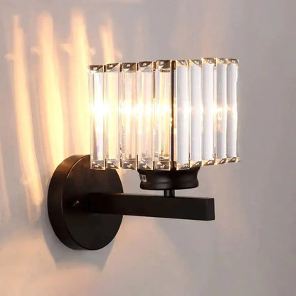 Modern minimalist wall lamp with black metal frame and vertical crystal rods for bedroom lighting