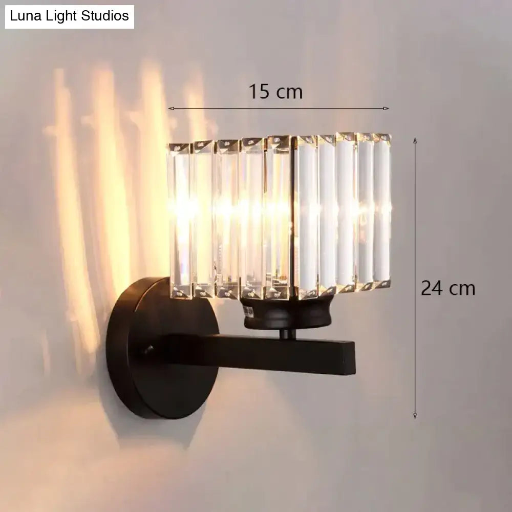 Modern minimalist wall lamp with black metal base and vertical crystal rods for elegant bedroom lighting