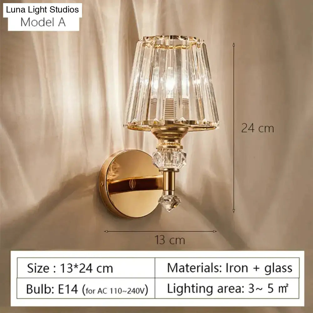 Modern minimalist gold wall lamp featuring a faceted crystal shade and decorative glass elements for bedroom use