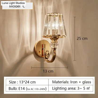 Modern minimalist gold wall lamp featuring a gold-toned sconce with faceted crystal glass shade and decorative accents