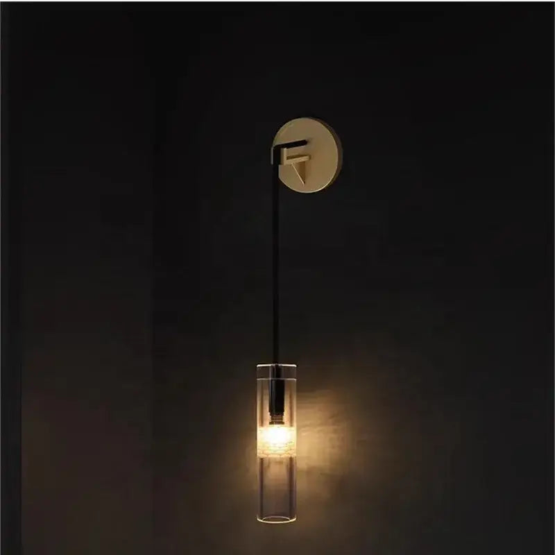 Minimalist wall lamp with sleek circular brass base black cable and transparent glass shade decorbites golden glass wall design