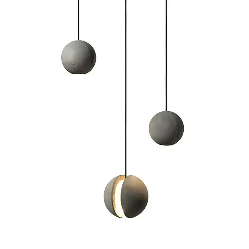 Modern minimalist gray pendant light with cement planet chandelier design and sleek black cords for dining room decorbites