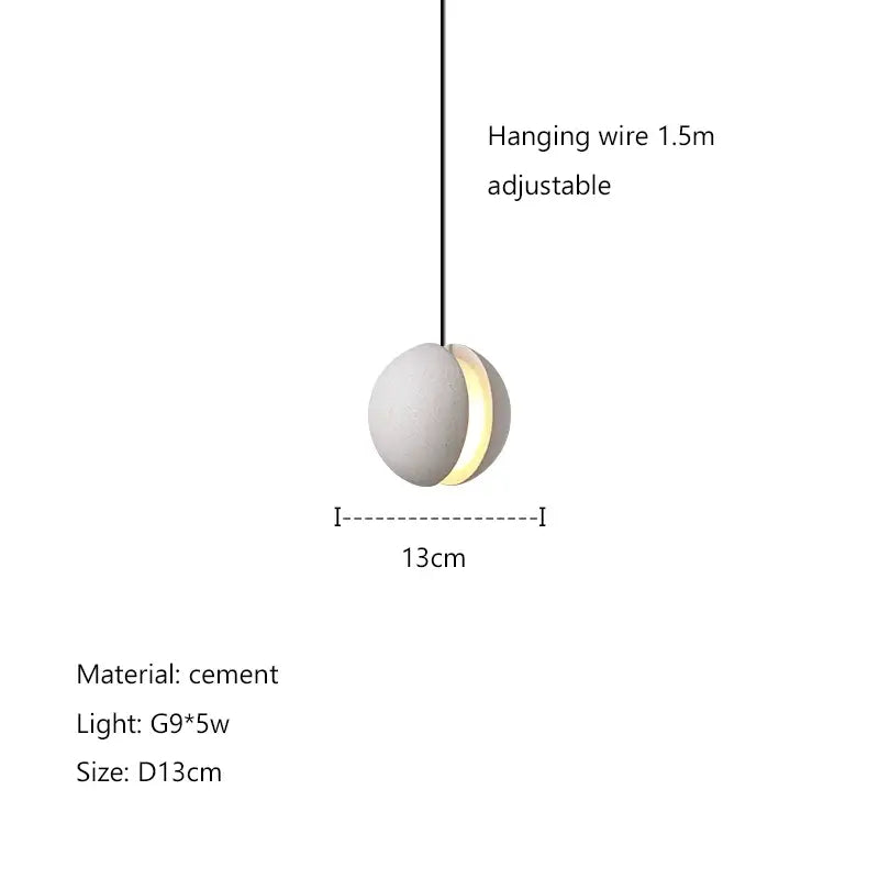 Modern minimalist gray and gold pendant light with matte white decorbites cement planet body and warm yellow glow