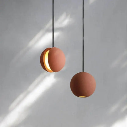 Modern minimalist gray and gold pendant light with terracotta spherical matte cement planet chandelier for dining room decorbites
