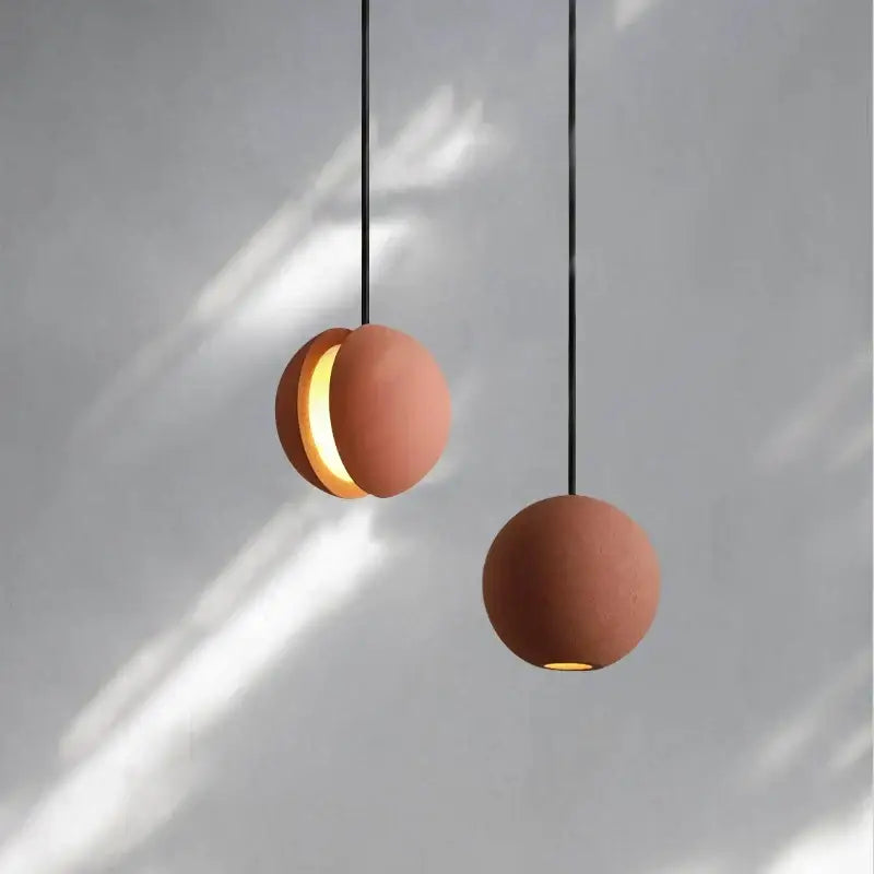 Modern minimalist gray and gold pendant light with terracotta spherical matte cement planet chandelier for dining room decorbites