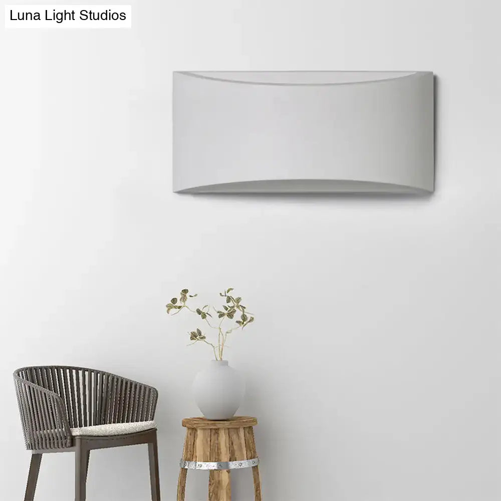 Modern minimalist gray curved wall sconce with a sleek matte finish designed as a bedroom led light fixture