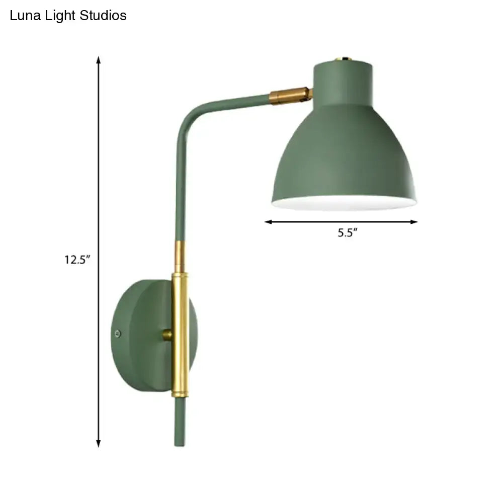 Modern sage green wall sconce with brass accents and curved arm using e27 bulb for bedroom lighting