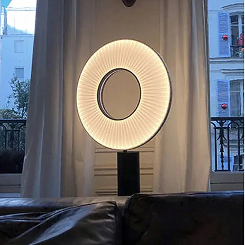 Modern minimalist dix iris pendant light with warm glowing ring and pleated fabric diffuser for dining room decor