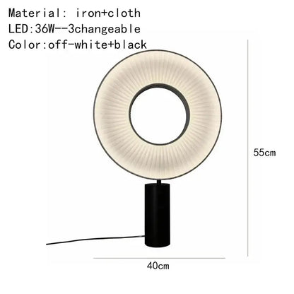 Modern minimalist dix iris pendant light with black iron base and pleated off-white cloth ring emitting soft light