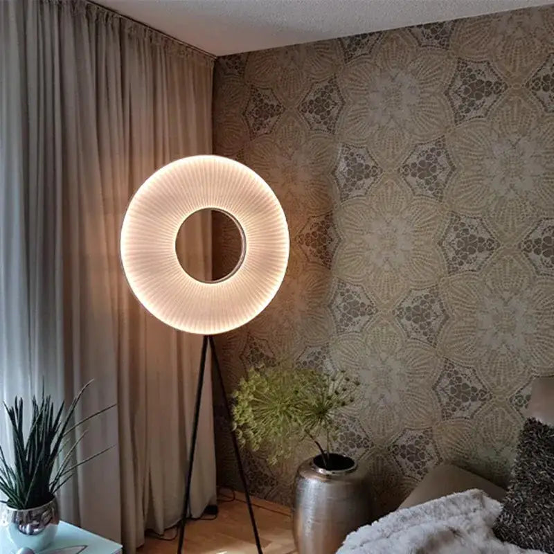 A modern minimalist dix iris pendant light with a warm ribbed shade and black tripod base for dining room decor