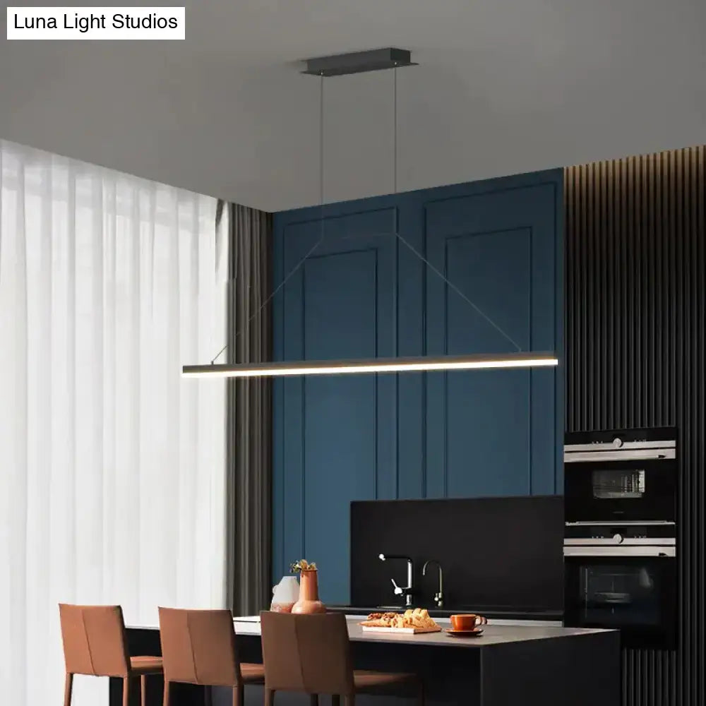 Modern minimalist led black pendant light with sleek rectangular design suspended above dining table ideal for dining room