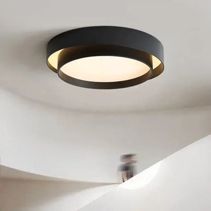 Modern minimalist black led ceiling light with circular concentric ring design and warm diffused glow for bedroom lighting