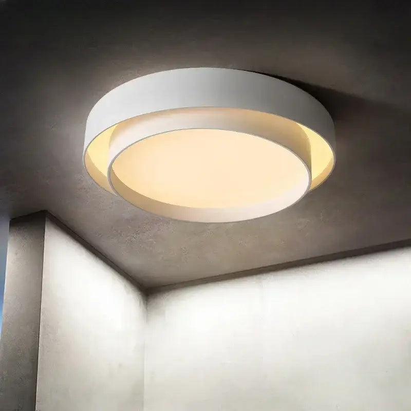 Modern minimalist led ceiling light white with warm glowing inner ring for bedroom lighting and sleek design