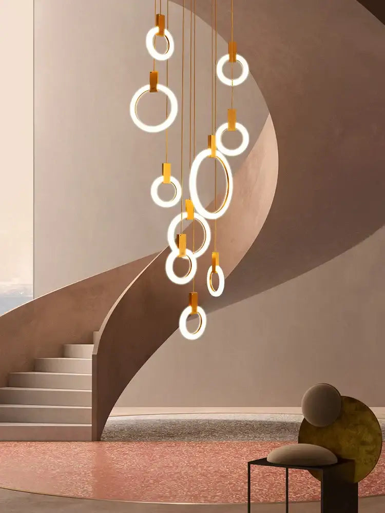 Modern minimalist ceiling lights with glowing circular rings and gold-toned rods for led wooden staircase decorbites