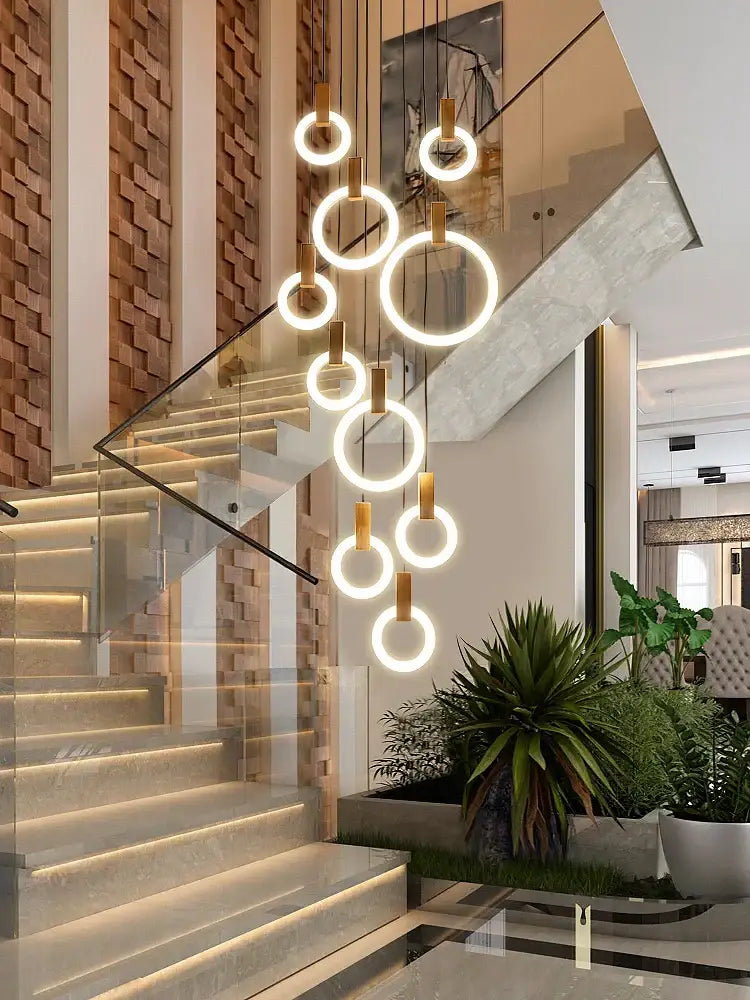 Modern minimalist led wooden staircase ceiling lights featuring warm glowing circular pendant rings for dining room decorbites
