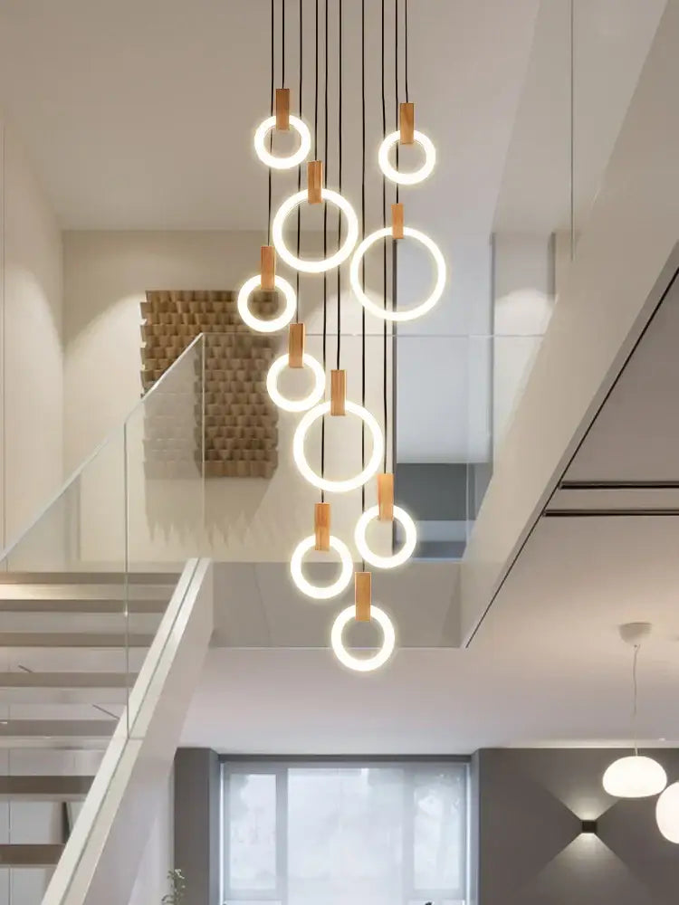 Modern minimalist led wooden staircase ceiling lights featuring glowing circular rings with black cords and wooden accents