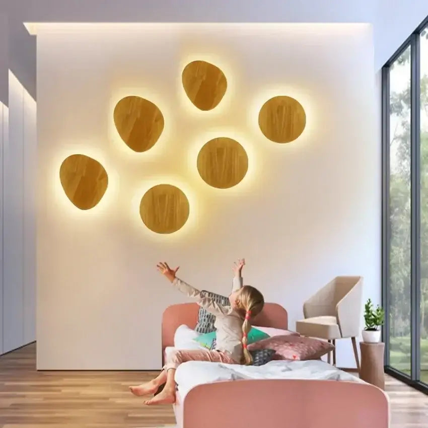 Set of seven warm-toned oval led wooden wall lights with modern minimalist design for living room decor by decorbites
