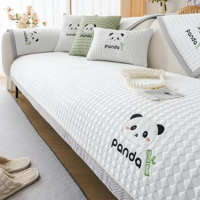 Modern minimalist light green sofa mat with white quilted cover featuring embroidered panda faces and bamboo motifs