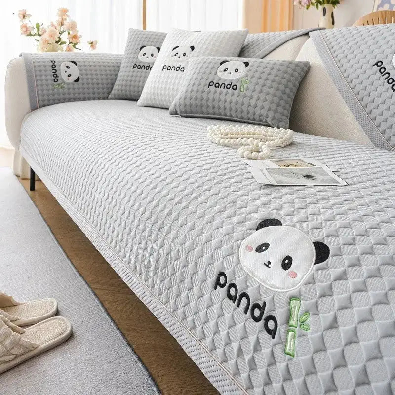 Gray quilted sofa cover with embroidered panda faces and bamboo motifs for modern minimalist light green living rooms