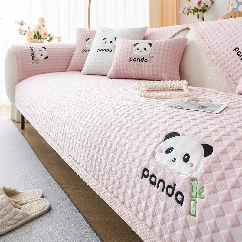 Pink quilted sofa cover with embroidered panda faces and bamboo motifs for modern minimalist light green living room seat