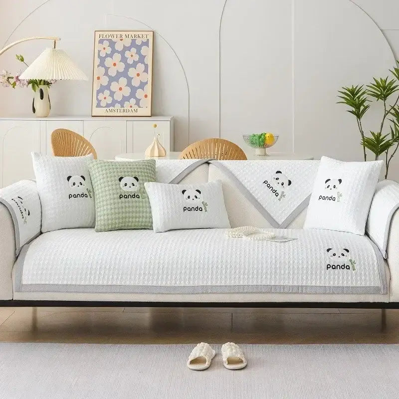 White quilted sofa cover with embroidered panda faces and gray trim for modern minimalist light green sofa mat