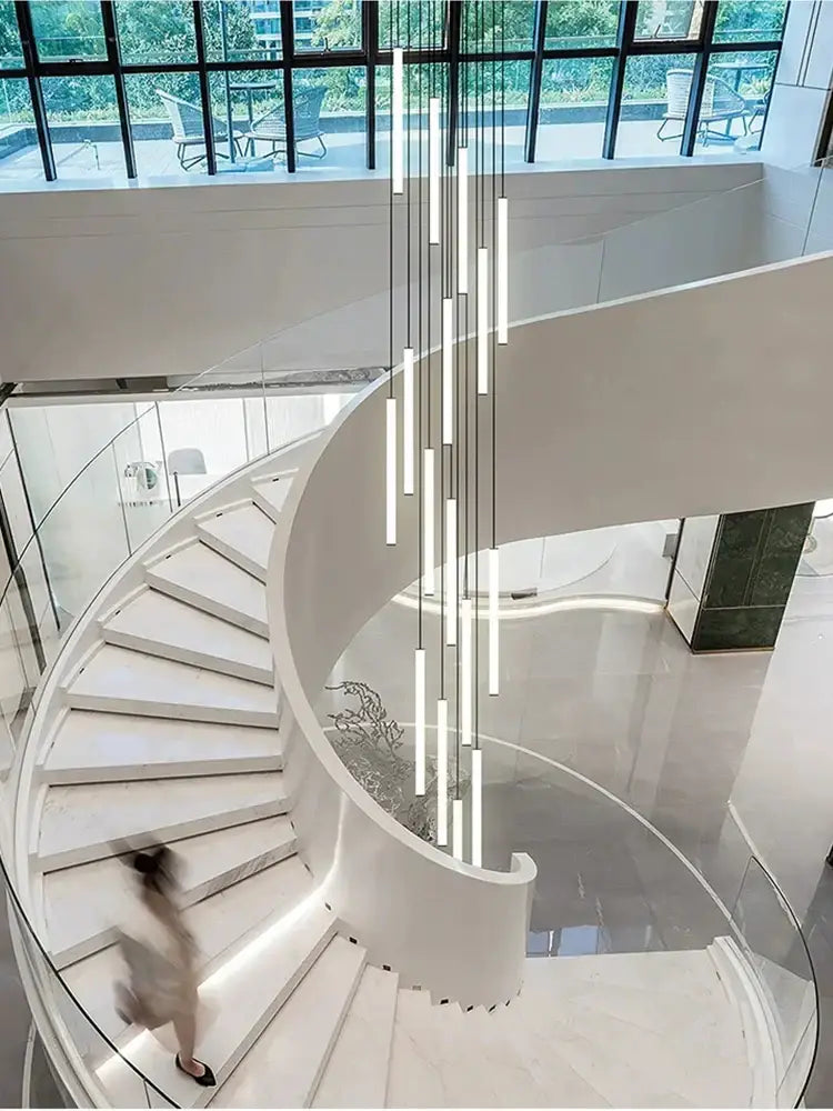 Modern white spiral staircase with glass railings and recessed lighting complementing decorbites loft black chandelier